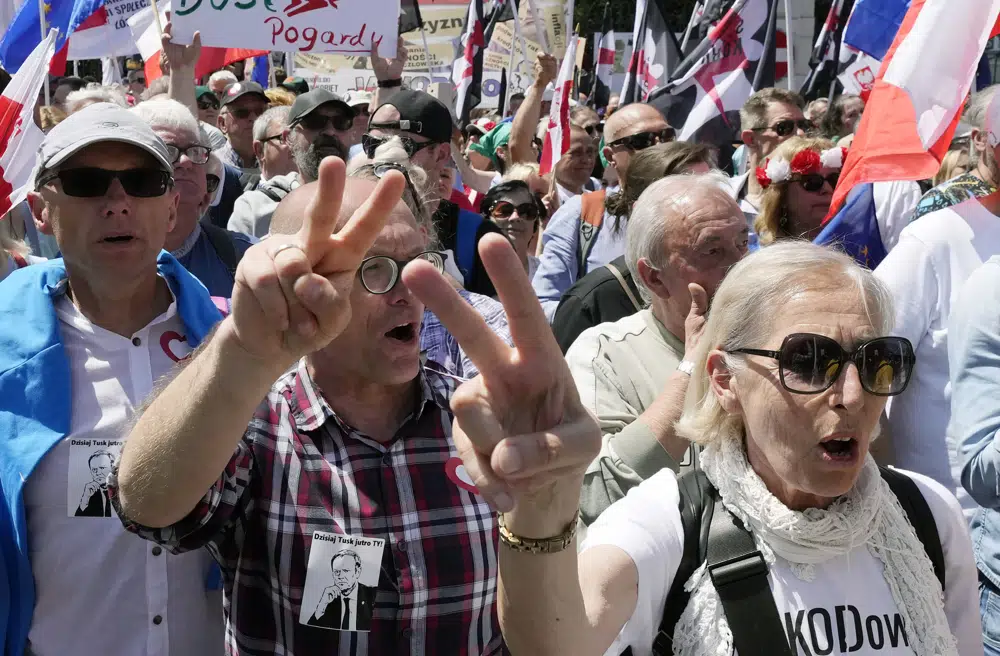 Participants join an anti-government march led by the centrist opposition party leader Donald Tusk, who along with other critics accuses the government of eroding democracy, in Warsaw, Poland, Sunday, June 4, 2023. Poland's largest opposition party led a march Sunday meant to mobilize voters against the right-wing government, which it accuses of eroding democracy and following Hungary and Turkey down the path to autocracy. The march is being held on the 34th anniversary of the first partly free elections, a democratic breakthrough in the toppling of communism across Eastern Europe. (AP Photo/Czarek Sokolowski)