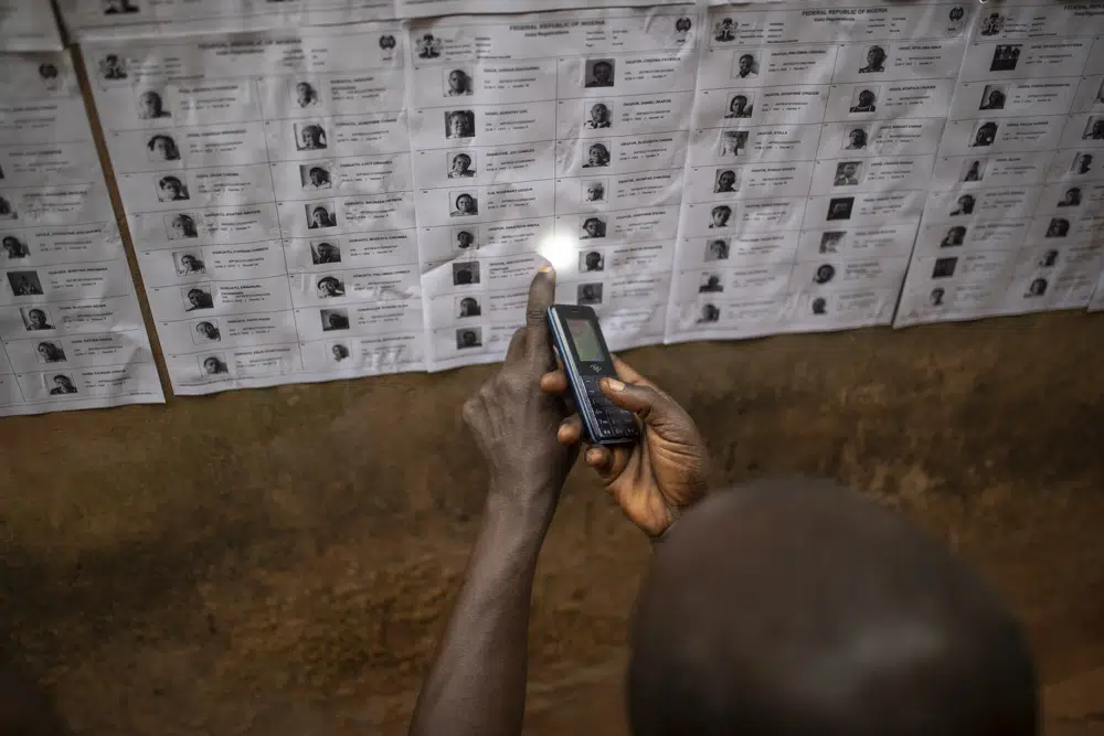 A man checks for his name on the voters registration list during the presidential elections in Agulu, Nigeria, Saturday, Feb. 25, 2023. Voters in Africa's most populous nation are heading to the polls Saturday to choose a new president, following the second and final term of incumbent Muhammadu Buhari. (AP Photo/Mosa'ab Elshamy)
