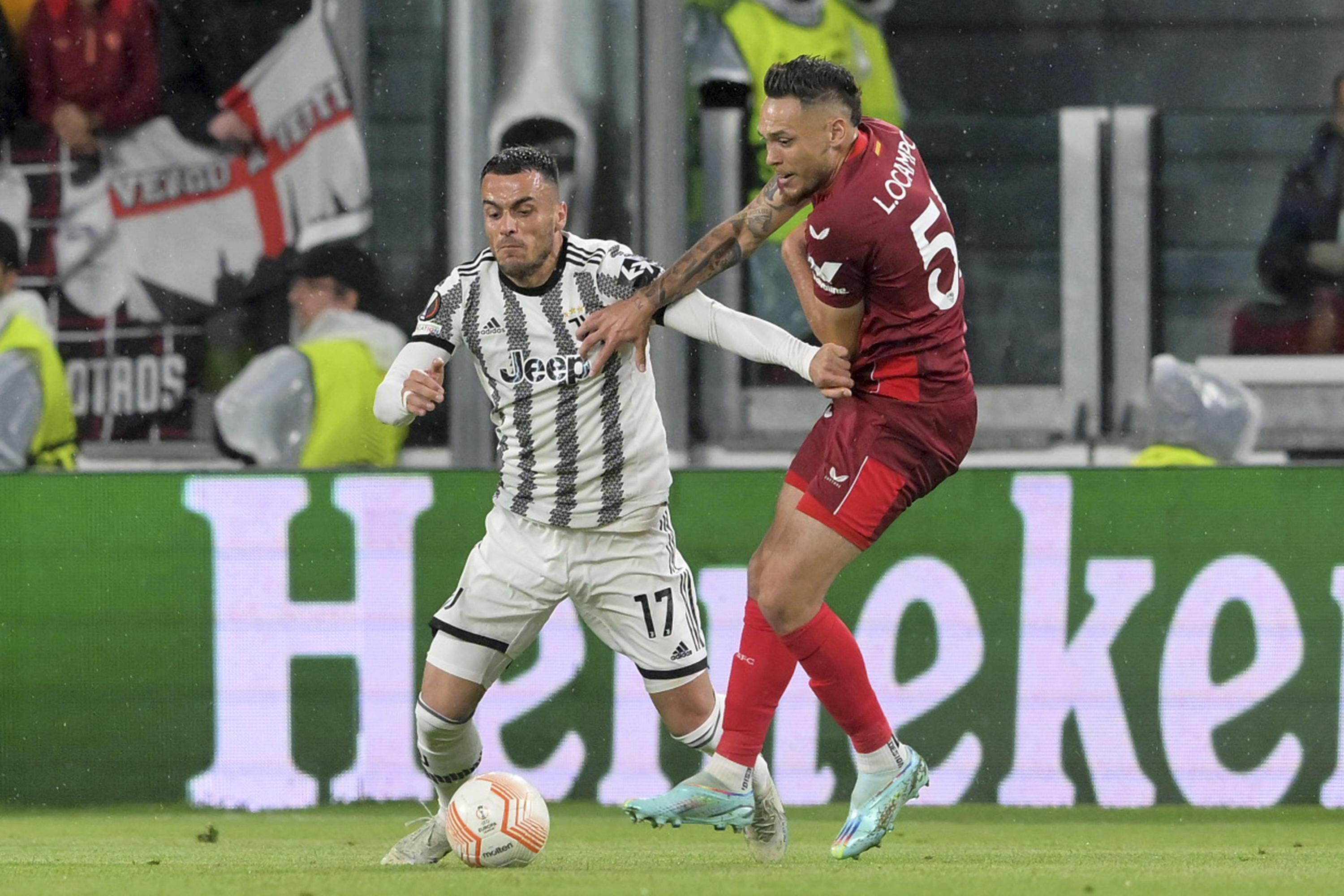 Sevilla's Loic Bade, top, heads the ball past Roma's Tammy Abraham