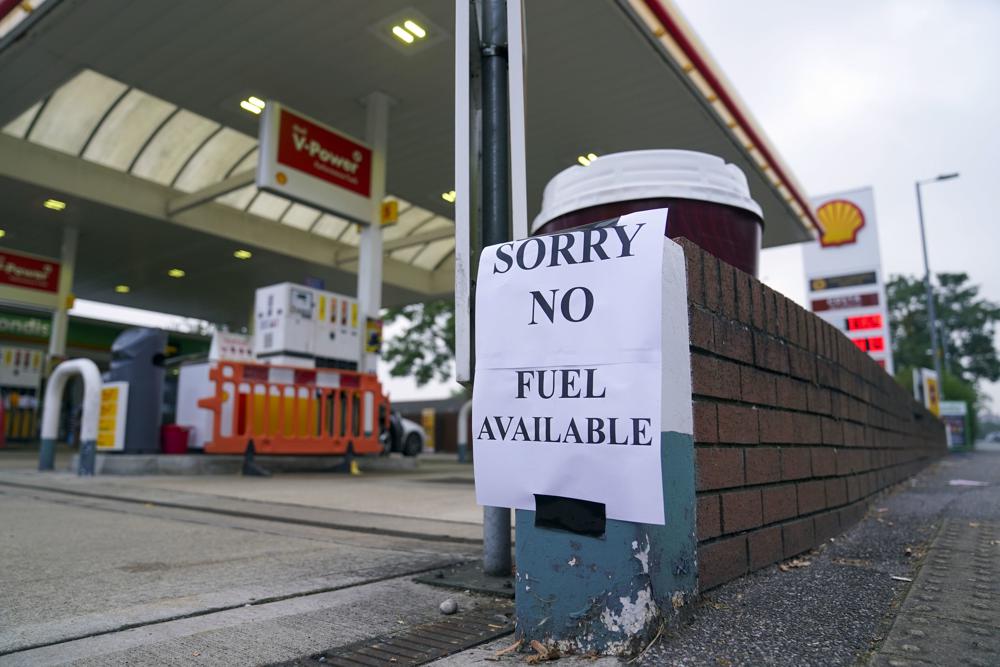 A view of a sign at a petrol station, in Bracknell England, Sunday Sept. 26, 2021. In a U-turn, Britain says it will issue thousands of emergency visas to foreign truck drivers to help fix supply-chain problems that have caused empty supermarket shelves, long lines at gas stations and shuttered petrol pumps. (Steve Parsons/PA via AP)