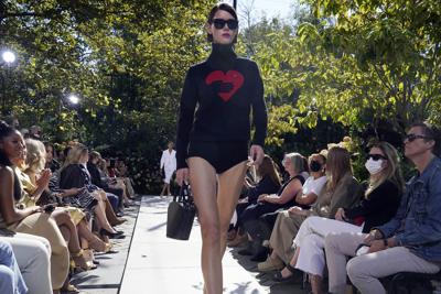 Michael Kors returns to NY Fashion Week with urban romance | AP News