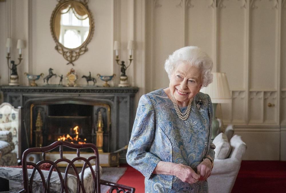 FILE - Britain's Queen Elizabeth II smiles while receiving the President of Switzerland Ignazio Cassis and his wife Paola Cassis during an audience at Windsor Castle in Windsor, England, Thursday, April 28, 2022. Queen Elizabeth II, Britain’s longest-reigning monarch and a rock of stability across much of a turbulent century, has died. She was 96. Buckingham Palace made the announcement in a statement on Thursday Sept. 8, 2022.(Dominic Lipinski/Pool Photo via AP, File)