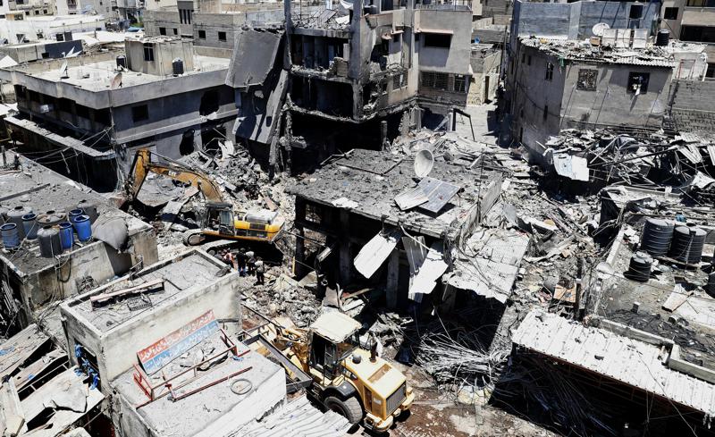 Palestinian rescuers and security personnel work at the scene of an explosion in the Al-Zawiya market area of Gaza City, Gaza, Thursday, July 22, 2021. At least one person was killed and some 10 injured Thursday when the explosion tore through a house in a popular market, the interior ministry said. (AP Photo/Adel Hana)