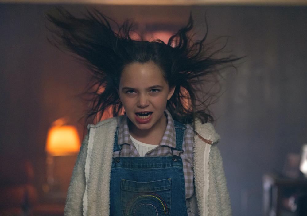 This image released by Universal Pictures shows Ryan Kiera Armstrong as Charlie in a scene from "Firestarter." (Ken Woroner/Universal Pictures via AP)