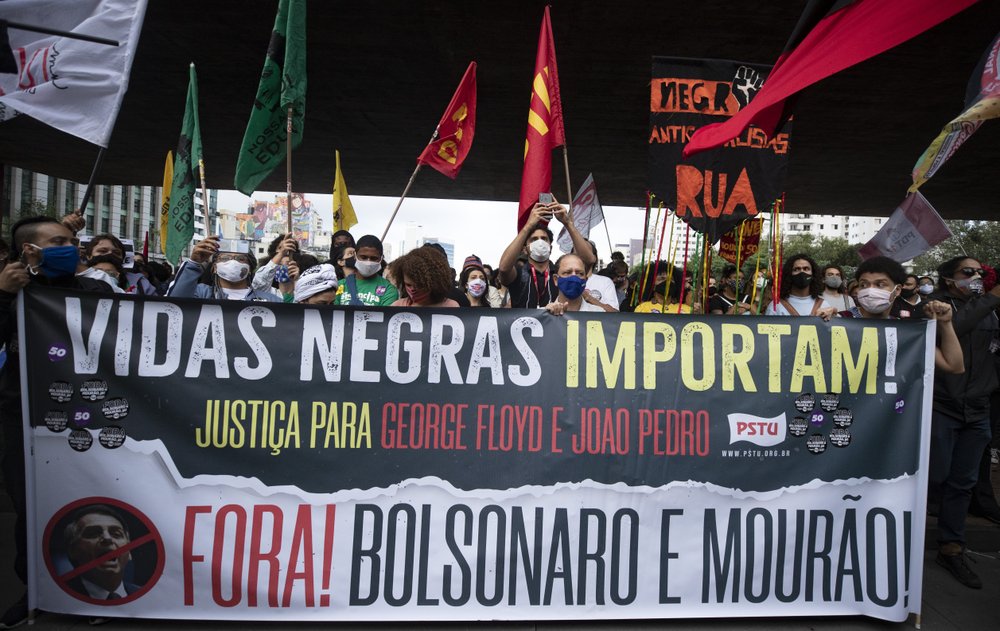 Activists including members of Black Lives Matter march against the murder of Black man Joao Alberto Silveira Freitas at a Carrefour supermarket the night before, on Brazil's National Black Consciousness Day in Sao Paulo, Brazil, Friday, Nov. 20, 2020. Freitas died after being beaten by supermarket security guards in the southern Brazilian city of Porto Alegre, sparking outrage as videos of the incident circulated on social media. (AP Photo/Andre Penner)