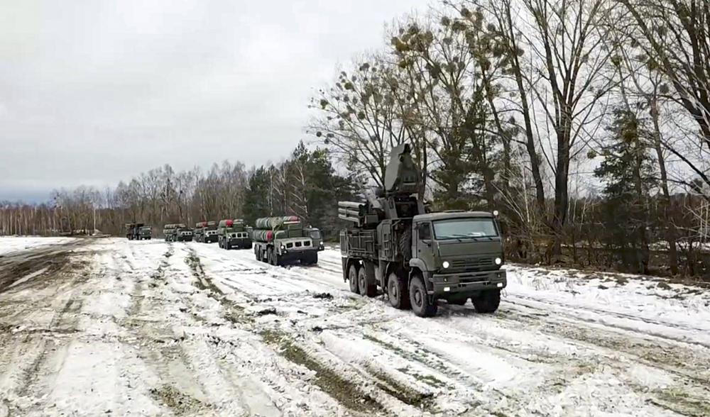 In this photo taken from video provided by the Russian Defense Ministry Press Service on Thursday, Feb. 10, 2022, combat crews of the S-400 air defense system drive to take up combat duty at the training ground in the Brest region during the Union Courage-2022 Russia-Belarus military drills in Belarus. (Russian Defense Ministry Press Service via AP)