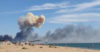 Rising smoke can be seen from the beach at Saky after explosions were heard from the direction of a Russian military airbase near Novofedorivka, Crimea, Tuesday Aug. 9, 2022. The explosion of munitions caused a fire at a military air base in Russian-annexed Crimea Tuesday but no casualties or damage to stationed warplanes, Russia's Defense Ministry said. (UGC via AP)