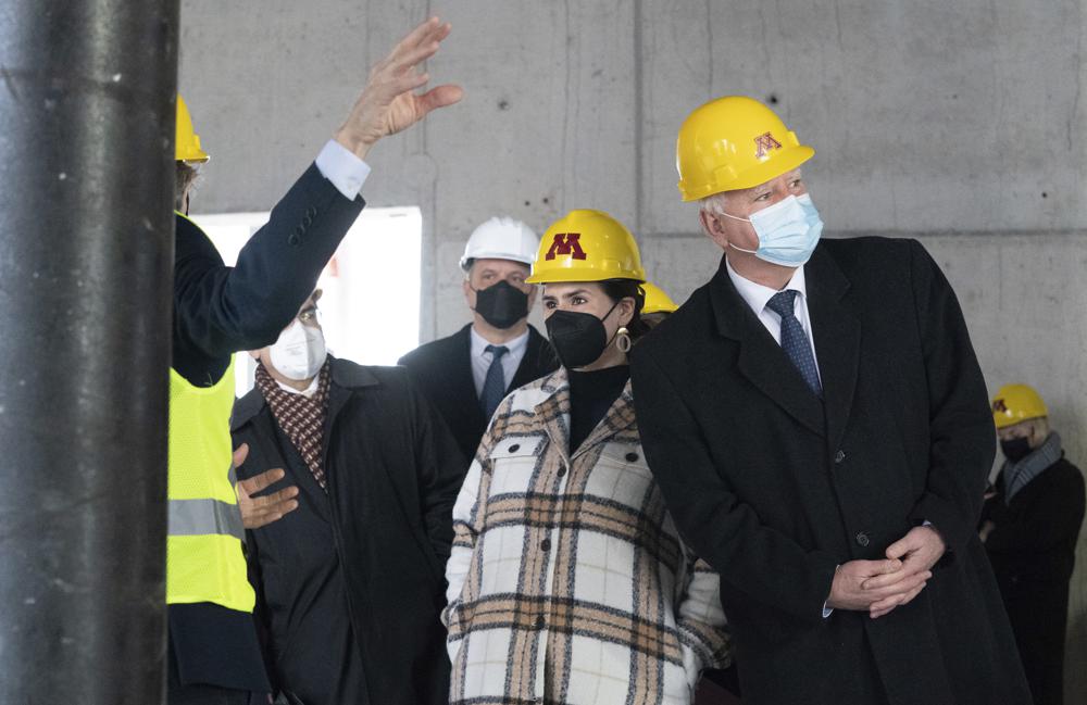 Gov. Tim Walz, right, and Lt. Gov. Peggy Flanagan tour a construction project at the University of Minnesota where they announced their $2.7 billion plan to bolster infrastructure across Minnesota, Tuesday, Jan. 18, 2022, in Minneapolis. (Glen Stubbe/Star Tribune via AP)