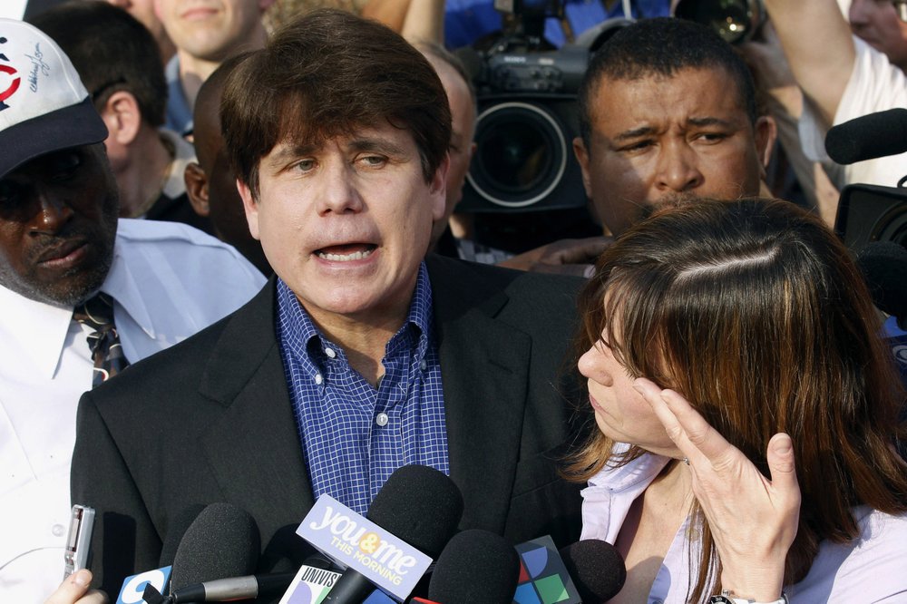 FILE - In this March 14, 2012, file photo, former Illinois Gov. Rod Blagojevich speaks to the media outside his home in Chicago as his wife, Patti, wipes away tears a day before reporting to prison after his conviction on corruption charges. President Donald Trump is expected to commute the 14-year prison sentence of Blagojevich. The 63-year-old Democrat is expected to walk out of prison later Tuesday, Feb. 18, 2020. (AP Photo/M. Spencer Green, File)