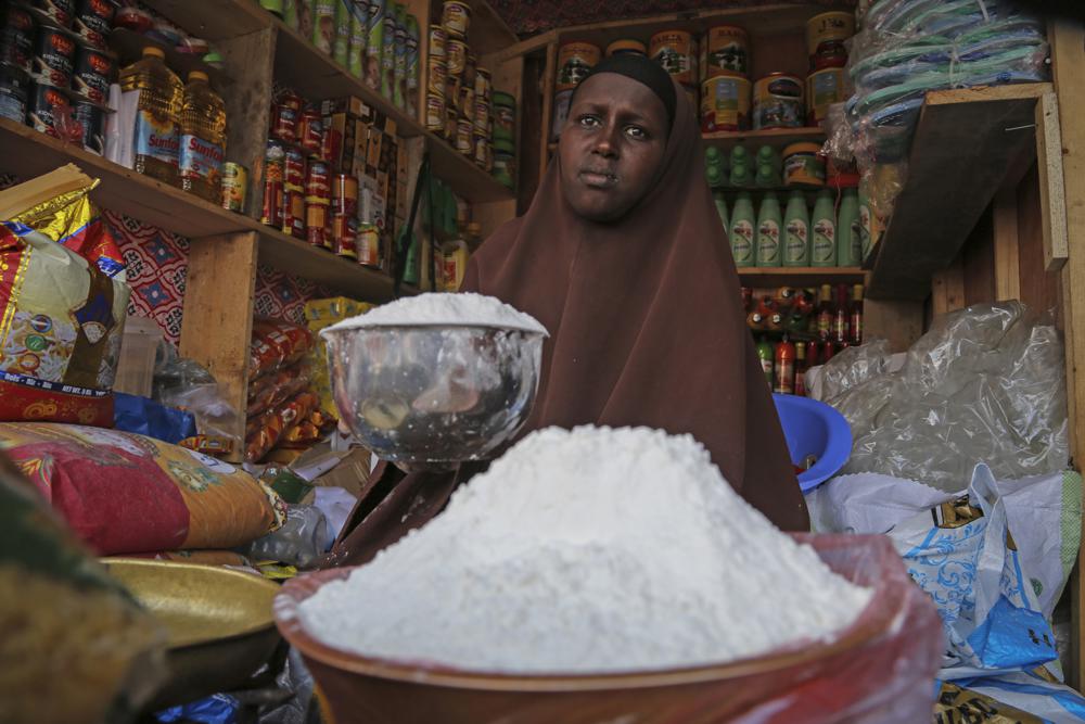 FILE - A shopkeeper sells wheat flour in the Hamar-Weyne market in the capital Mogadishu, Somalia on May 26, 2022. Africa is actually taken hostage in Russia's invasion of Ukraine amid catastrophically rising food prices, Ukrainian President Volodymyr Zelenskyy told the African Union during a closed-door address on Monday, June 20, 2022. (AP Photo/Farah Abdi Warsameh, File)