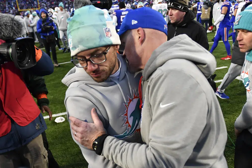 Buffalo Bills head coach Sean McDermott, right, greets Miami Dolphins head coach Mike McDaniel after an NFL wild-card playoff football game, Sunday, Jan. 15, 2023, in Orchard Park, N.Y. (AP Photo/Adrian Kraus)