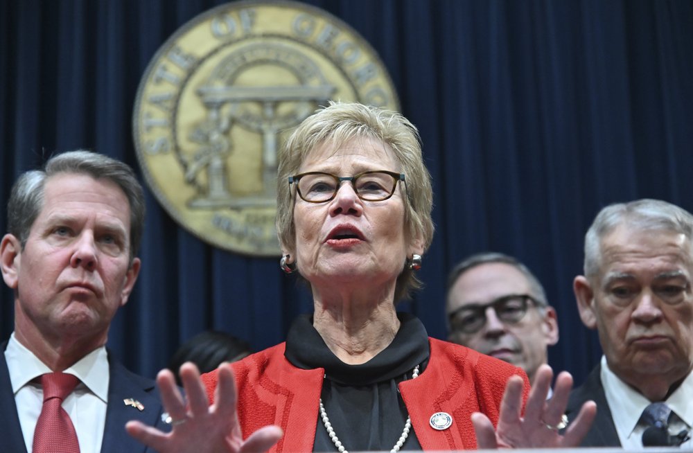 FILE - In this Thursday, March 12, 2020 file photo, Dr. Kathleen Toomey, commissioner of the Georgia Department of Public Health, speaks during a news conference at the Georgia State Capitol in Atlanta to provide an update on the state's efforts regarding COVID-19, after reporting the first death in Georgia related to coronavirus. With the increased public scrutiny, security details have been assigned to Dr. Anthony Fauci, the nation's top infectious disease expert, and top state health officials like Toomey and Ohio's Dr. Amy Acton following protests by armed demonstrators and threats against the two women. (Hyosub Shin/Atlanta Journal-Constitution via AP)