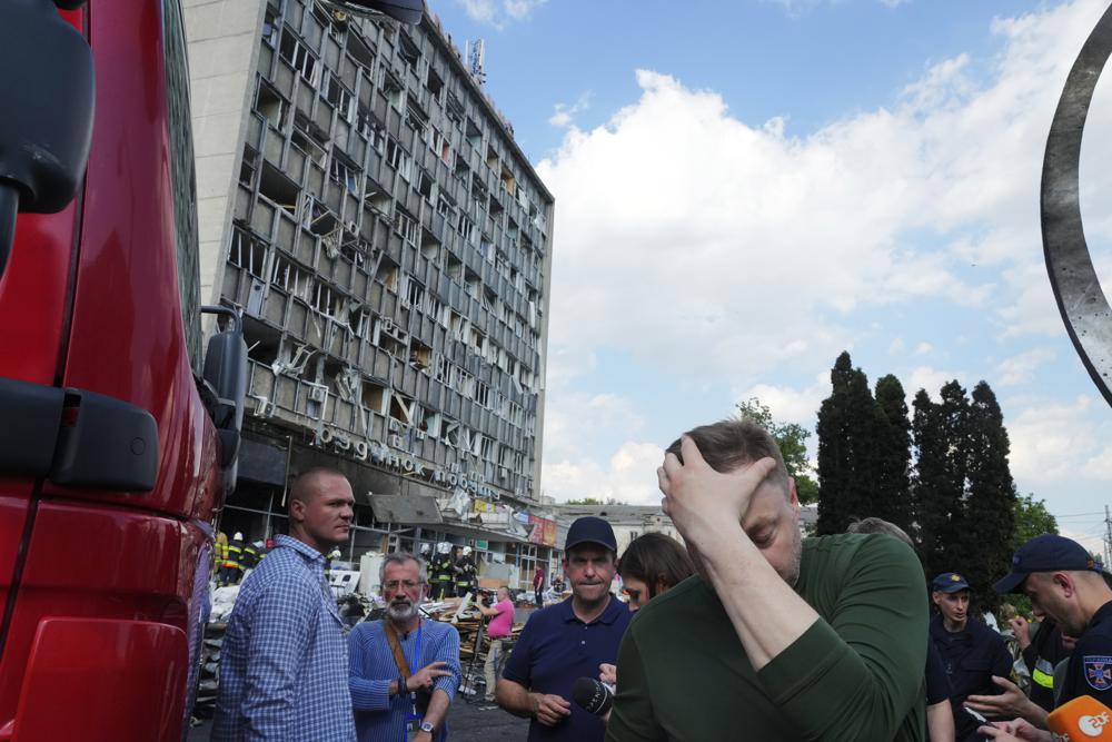 El ministro del Interior de Ucrania, Denys Monastyrsky, en el centro a la derecha, reacciona en una escena de edificio dañado por bombardeos en Vinnytsia, Ucrania, el jueves 14 de julio de 2022. Misiles rusos que impactaron en una ciudad en el centro de Ucrania mataron a 17 personas e hirieron a unas 90 más el jueves, Ucrania dijeron las autoridades. (Foto AP/Efrem Lukatsky)