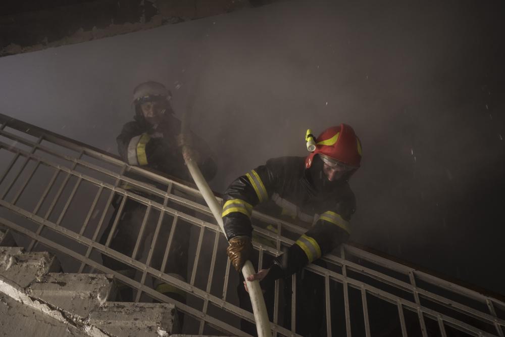 Firefighters work to extinguish a fire after a Russian attack in Kharkiv, Ukraine, Saturday, April 16, 2022. (AP Photo/Felipe Dana)