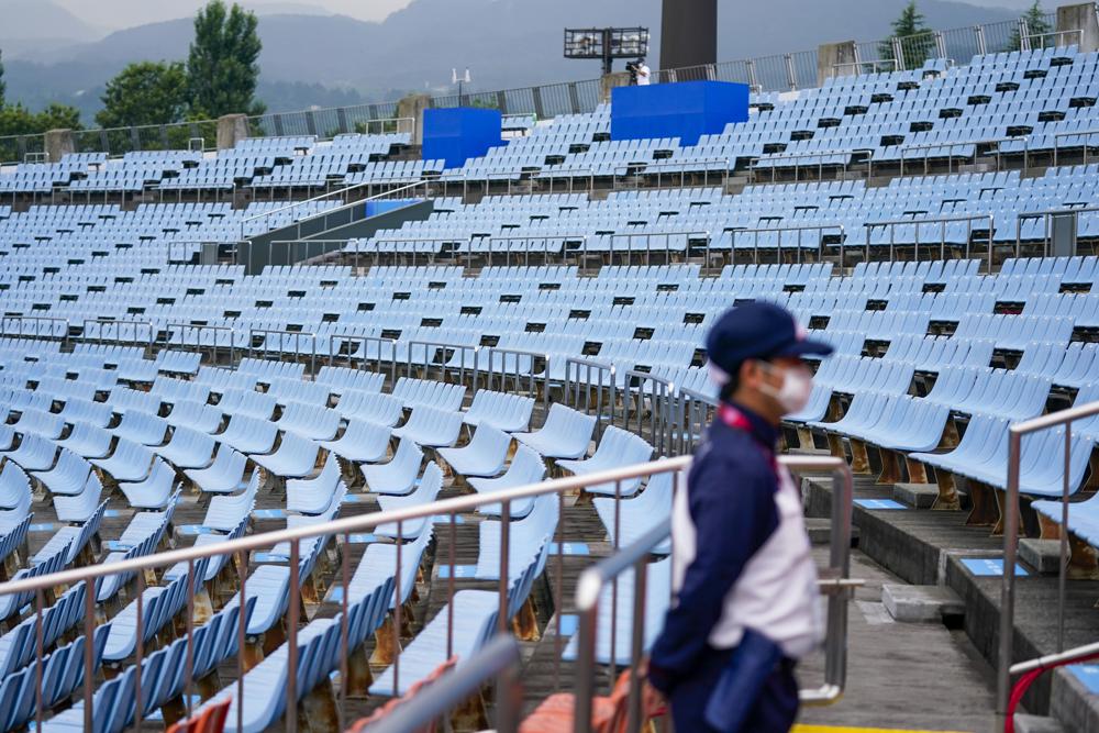 FILE - In this July 22, 2021, file photo, a steward stands in the empty stands at the softball game between the Mexico and Japan at the 2020 Summer Olympics in Fukushima , Japan. (AP Photo/Jae C. Hong, File)