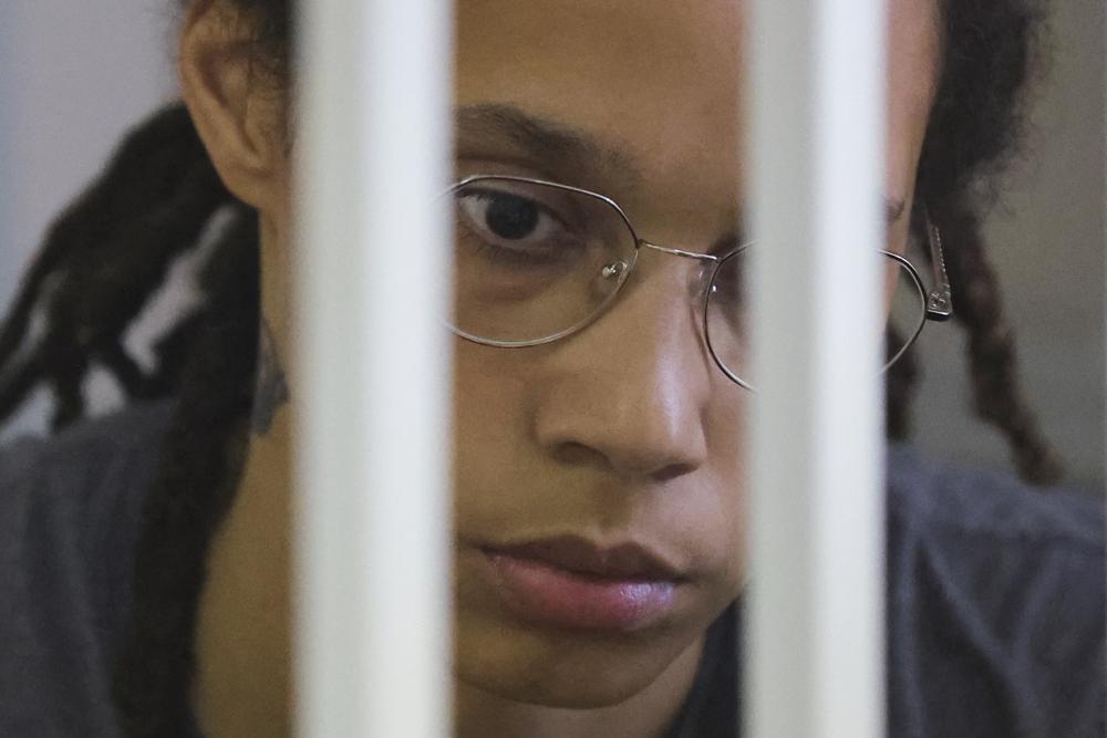 WNBA star and two-time Olympic gold medalist Brittney Griner awaits the verdict standing in a cage in a courtroom in Khimki just outside Moscow, Russia, Thursday, Aug. 4, 2022. American basketball star Brittney Griner apologized to her family and teams as a Russian court heard closing arguments in her drug possession trial said it expected to deliver a verdict later Thursday. (Evgenia Novozhenina/Pool Photo via AP)
