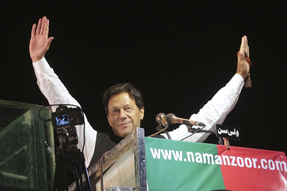 FILE - Former Pakistani Prime Minister Imran Khan waves to his supporters during an anti-government rally, in Lahore, Pakistan, April 21, 2022. Khan called on Sunday, May 22, 2022, for his supporters to march peacefully on Islamabad on May 25th, to press for fresh elections. Khan, who served as prime minister for over three and half years, was ousted in a no-confidence vote in parliament by an alliance of all major political parties. (AP Photo/K.M. Chaudary, File)