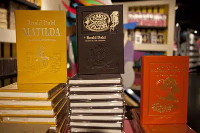 FILE - Books by Roald Dahl are displayed at the Barney's store on East 60th Street in New York on Monday, Nov. 21, 2011. Critics are accusing the publisher of Roald Dahl’s classic children’s books of censorship after it removed colorful language from stories such as “Charlie and the Chocolate Factory” and “Matilda” to make them more acceptable to modern readers. (AP Photo/Andrew Burton, File)