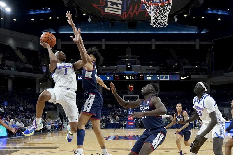 DePaul's Javan Johnson (1) shoots under pressure from Connecticut's Andre Jackson during the first half of an NCAA college basketball game Saturday, Jan. 29, 2022, in Chicago. (AP Photo/Charles Rex Arbogast)