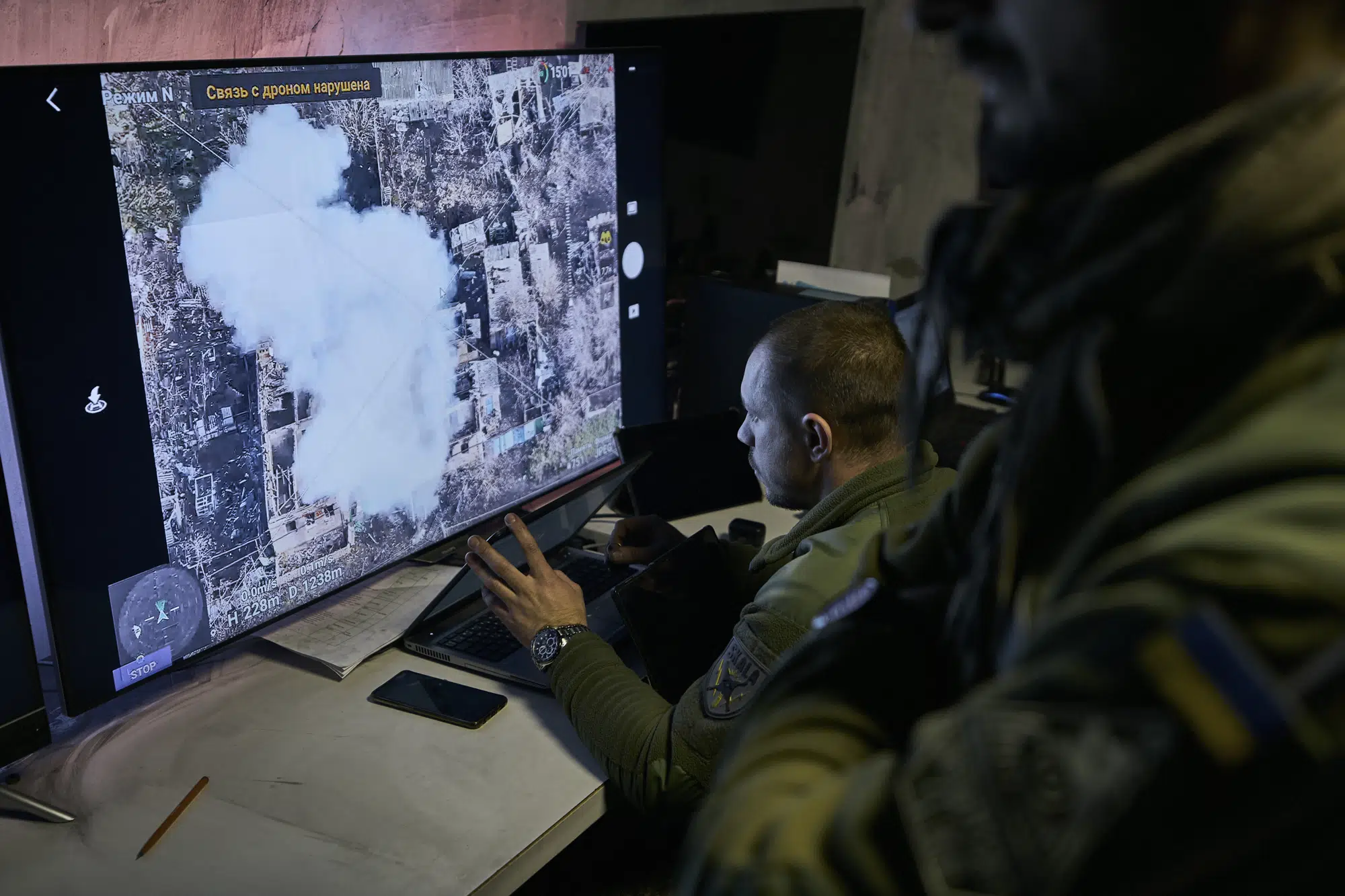 FILE - Ukrainian soldiers watch a drone feed from an underground command center in Bakhmut, Donetsk region, Ukraine, Sunday, Dec. 25, 2022. (AP Photo/Libkos, File)