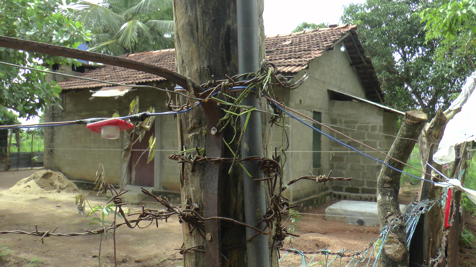 Illegally erected electric fence and traps set up to prevent wild elephants from entering human settlements are seen in Ashraf Nagar in Ampara district, about 210 kilometers (130 miles) east of the capital Colombo, Tuesday, Jan. 11, 2022. Conservationists and veterinarians are warning that plastic waste in an open landfill in Ampara is killing elephants in the region, after two more were found dead over the weekend. Their numbers have dwindled from about 14,000 in the 19th century to 6,000 in 2011, according to the country's first elephant census. They are increasingly vulnerable because of the loss and degradation of their natural habitat. Many venture closer to human settlements in search of food, and some are killed by poachers or farmers angry over damage to their crops. (AP Photo/Achala Pussalla)