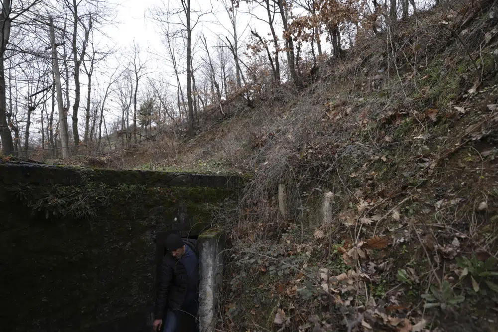 Tourist guide Afrim Cenaj exits from one of the underground tunnels on a former military unit of the city of Kukes, about 150 kilometers (90 miles) north of Tirana, Albania, Wednesday, March 15, 2023. A new underground museum of tunnels built during the former communist regime to shelter residents in case of a war will serve Kukes, Albania’s poorest district, to attract tourists. (AP Photo/Franc Zhurda)