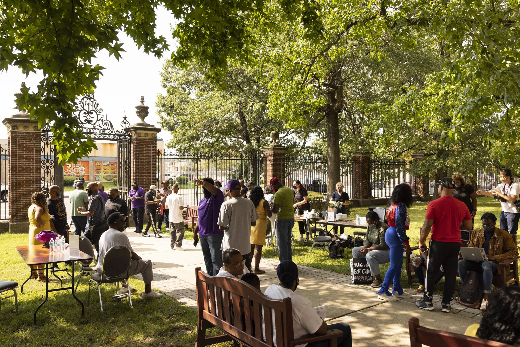 People gather for The Gun Violence Memorial Project set up outside Prince Hall Grand Lodge in Philadelphia on Monday, Aug. 23, 2021. The project collects momentos from families affected by gun violence to display at the National Building Museum in Washington. (AP Photo/Ryan Collerd)