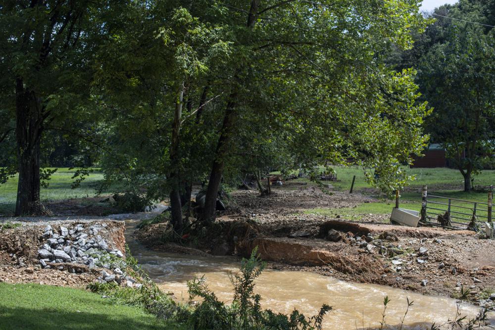 A driveway bridge is washed away by flooding along Little Blue Creek Road following heavy rainfall Saturday, Aug. 21, 2021, in McEwen, Tenn. Heavy flooding in several Middle Tennessee counties on Saturday prompted water rescues, road closures, and communications disruptions, with several people reported missing. Flash flood warnings were in effect for Dickson, Houston and Montgomery and Stewart counties on Saturday evening. (Josie Norris/The Tennessean via AP)