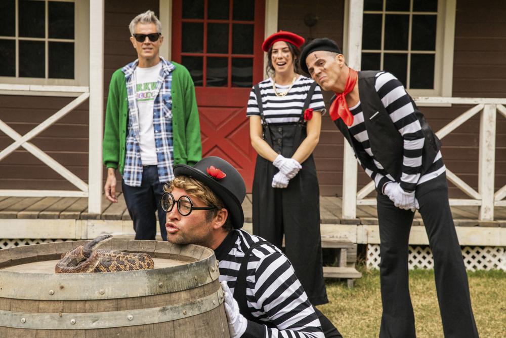 This image released by Paramount Pictures shows, from left, Johnny Knoxville, Sean "Poopies" McInerny, Rachel Wolfson and Steve-O in a scene from "Jackass Forever." (Sean Cliver/Paramount Pictures via AP)