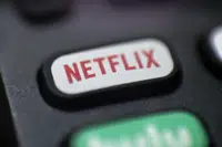 FILE - The Netflix logo is pictured on a remote control in Portland, Ore., Aug. 13, 2020. Netflix said Wednesday, Dec. 21, 2022, that it plans to build a state-of-the-art production facility at a former Army base at the Jersey Shore that will cost more than $900 million, and create thousands of jobs. (AP Photo/Jenny Kane, File)