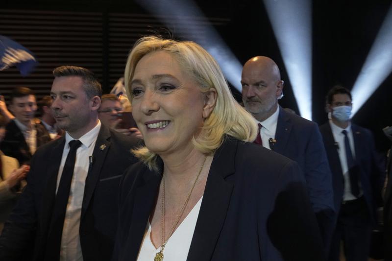 French far right presidential candidate Marine Le Pen smiles during a campaign rally, Saturday, Feb. 5, 2022 in Reims, eastern France. France's dueling far-right presidential candidates Eric Zemmour and Marine Le Pen are holding back-to-back campaign rallies Saturday, trying to steal each other's thunder and keep their anti-immigration, anti-Islam agenda front-and-center in the race for the April presidential election. (AP Photo/Michel Euler)