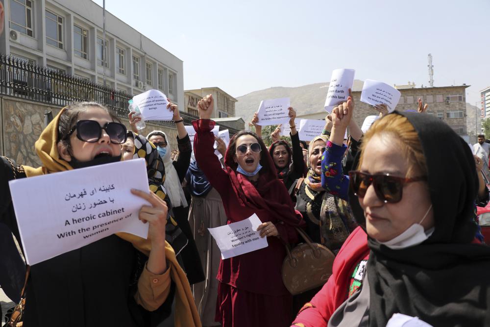 Women gather to demand their rights under the Taliban rule during a protest in Kabul, Afghanistan, Friday, Sept. 3, 2021. As the world watches intently for clues on how the Taliban will govern, their treatment of the media will be a key indicator, along with their policies toward women. When they ruled Afghanistan between 1996-2001, they enforced a harsh interpretation of Islam, barring girls and women from schools and public life, and brutally suppressing dissent. (AP Photo/Wali Sabawoon)