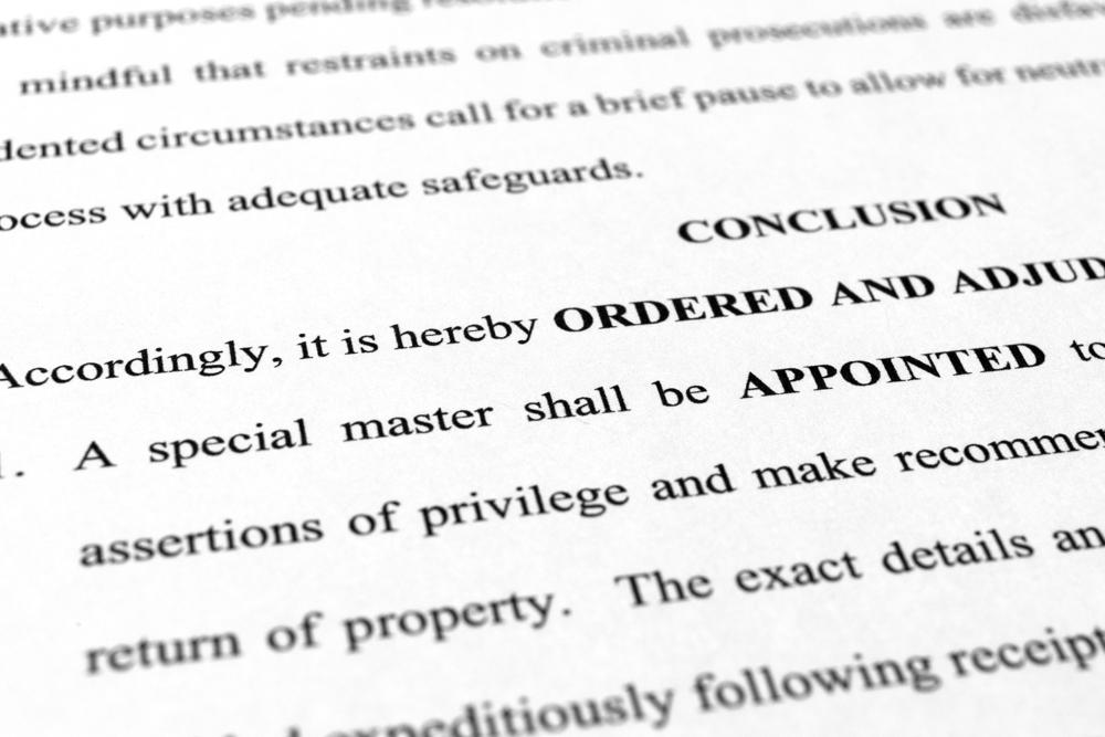 A page from the order granting a request by former President Donald Trump's legal team to appoint a special master to review documents seized by the FBI during a search of his Mar-a-Lago estate is photographed Monday, Sept. 5, 2022. The decision by U.S. District Judge Aileen Cannon came despite the objections of the Justice Department, which said an outside legal expert was not necessary in part because officials had already completed their review of potentially privileged documents. (AP Photo/Jon Elswick)