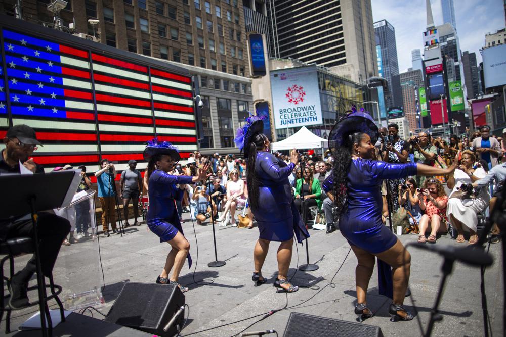 Selena Quinn, from left, LaVon Fisher-Wilson and Traci Coleman perform during a free outdoor event organized by The Broadway League as Juneteenth's celebrations take place at Times Square Saturday, June 19, 2021, in New York. Parades, picnics and lessons in history marked Juneteenth celebrations in the U.S., a day that marks the arrival of news to enslaved Black people in a Texas town that the Confederacy had surrendered in 1865 and they were free. (AP Photo/Eduardo Munoz Alvarez)
