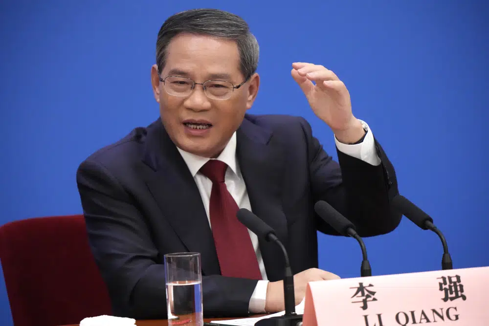 Chinese Premier Li Qiang gestures during a press conference after the closing ceremony for China's National People's Congress (NPC) at the Great Hall of the People in Beijing, Monday, March 13, 2023. (AP Photo/Mark Schiefelbein)