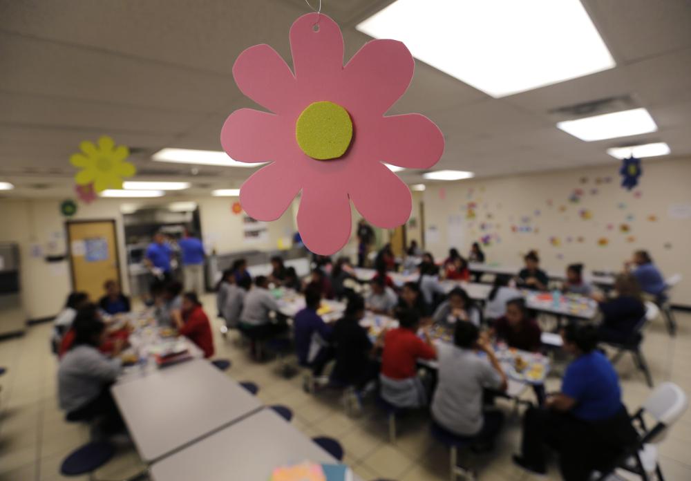 FILE - Migrant teens eat lunch at a tender-age facility for babies, children and teens, in Texas' Rio Grande Valley, on Aug. 29, 2019, in San Benito, Texas. The American Civil Liberties Union says the Department of Justice has withdrawn from talks to settle lawsuits filed on behalf of parents and children who were separated under the Trump administration's zero-tolerance border enforcement policy. (AP Photo/Eric Gay, File)