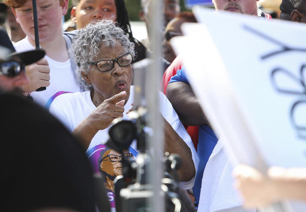 Opal Lee, 94, reacts to one of the many signs held by those participating in her annual Juneteenth walk on Saturday, June 19, 2021, in Fort Worth, Texas. Lee has been advocating for Juneteenth to be a federal holiday for many years and succeeded in her goal when President Joe Biden signed a bill on Thursday, making Juneteenth a national holiday. (Amanda McCoy/Star-Telegram via AP)
