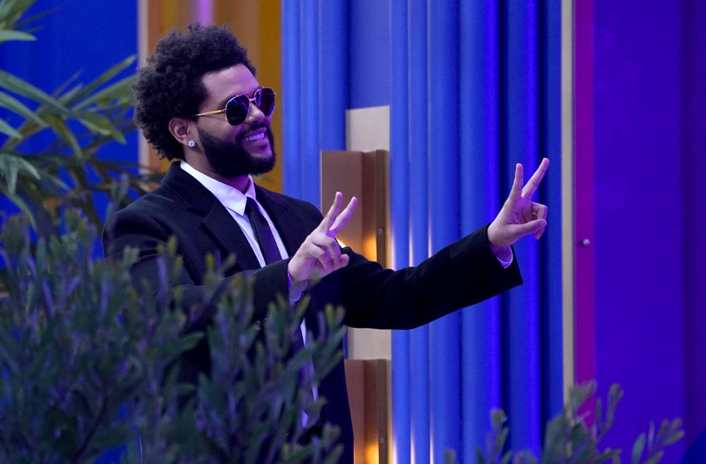 The Weeknd gestures to the crowd after accepting the top artist award at the Billboard Music Awards on Sunday, May 23, 2021, at the Microsoft Theater in Los Angeles. (AP Photo/Chris Pizzello)