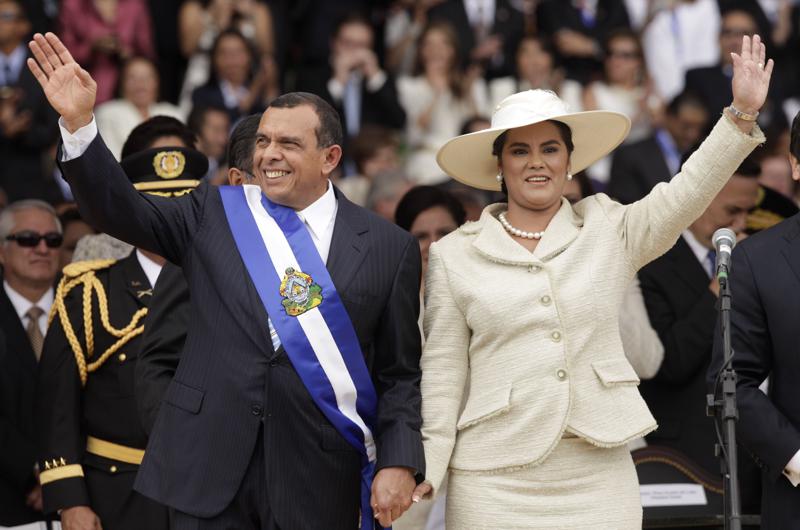 FILE - In this Jan. 27, 2010 file photo, wearing the presidential sash, Honduran President Porfirio Lobo and his wife First Lady Rosa Elena wave after Lobo was sworn in as the new president during his inauguration ceremony in Tegucigalpa. The U.S. State Department has named in a report released on Thursday, July 1, 2021 more than 50 current and former officials suspected of corruption or undermining democracy in three Central American countries, including the former Honduran first couple, saying Lobo took bribes from a drug cartel and his wife was involved in fraud and misappropriation of funds. Both deny the allegations.  (AP Photo/Arnulfo Franco, File)