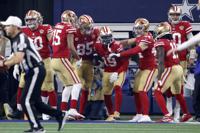 San Francisco 49ers' Jauan Jennings (15), George Kittle (85), Kyle Juszczyk (44), Brandon Aiyuk (11) and Jimmy Garoppolo, right, celebrate with Deebo Samuel (19) after his touchdown catch in the second half of an NFL wild-card playoff football game in Arlington, Texas, Sunday, Jan. 16, 2022. (AP Photo/Ron Jenkins)