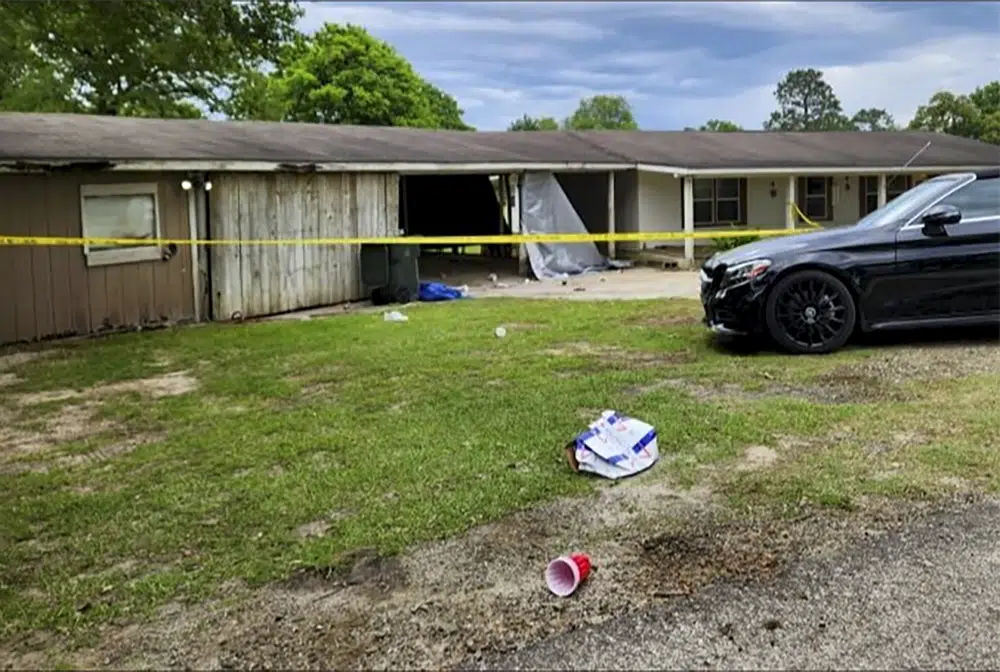 In this photo provided by KJAS, Jasper, Texas, crime scene tape cordons off the scene of a shooting, Sunday, April 23, 2023, in Jasper, Texas. Officials said gunfire at a huge prom after-party at the home injured multiple teenagers, and a second shooting in a nearby city is being investigated for a possible connection. (Mike Lout/KJAS, Jasper, Texas via AP)