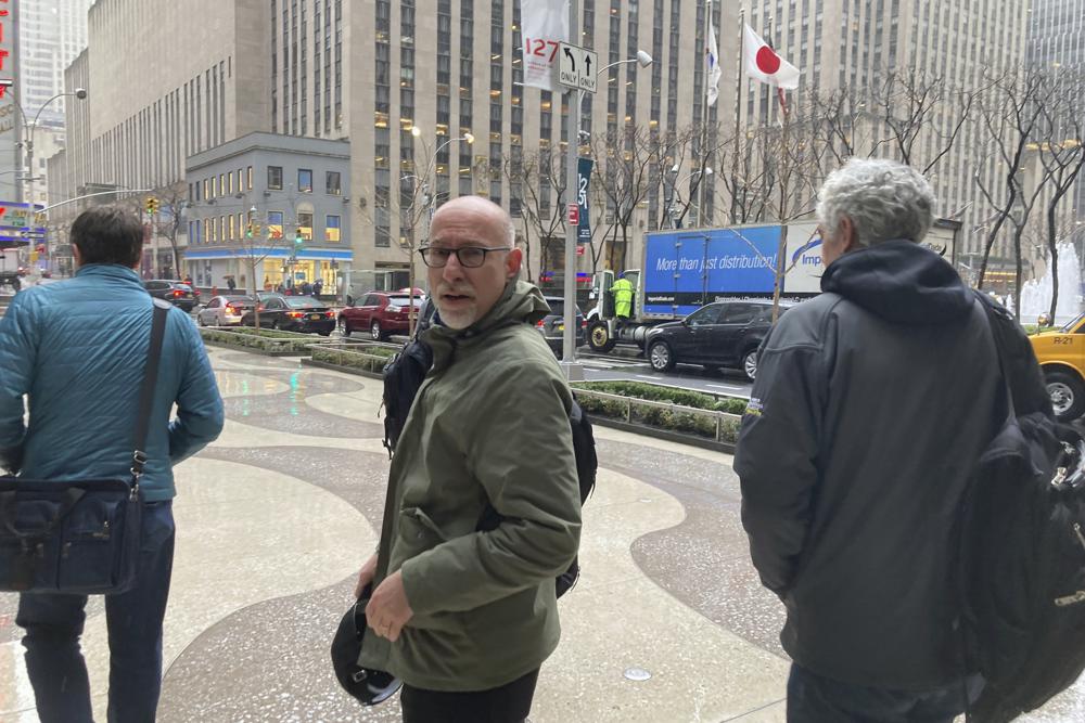 Chief union negotiator Bruce Meyer, center, and general counsel Ian Penny, right, leave Major League Baseball’s office in New York, Wednesday, March 9, 2022. Negotiators for locked-out players made their latest counteroffer to Major League Baseball on Wednesday. (AP Photo/Ron Blum)