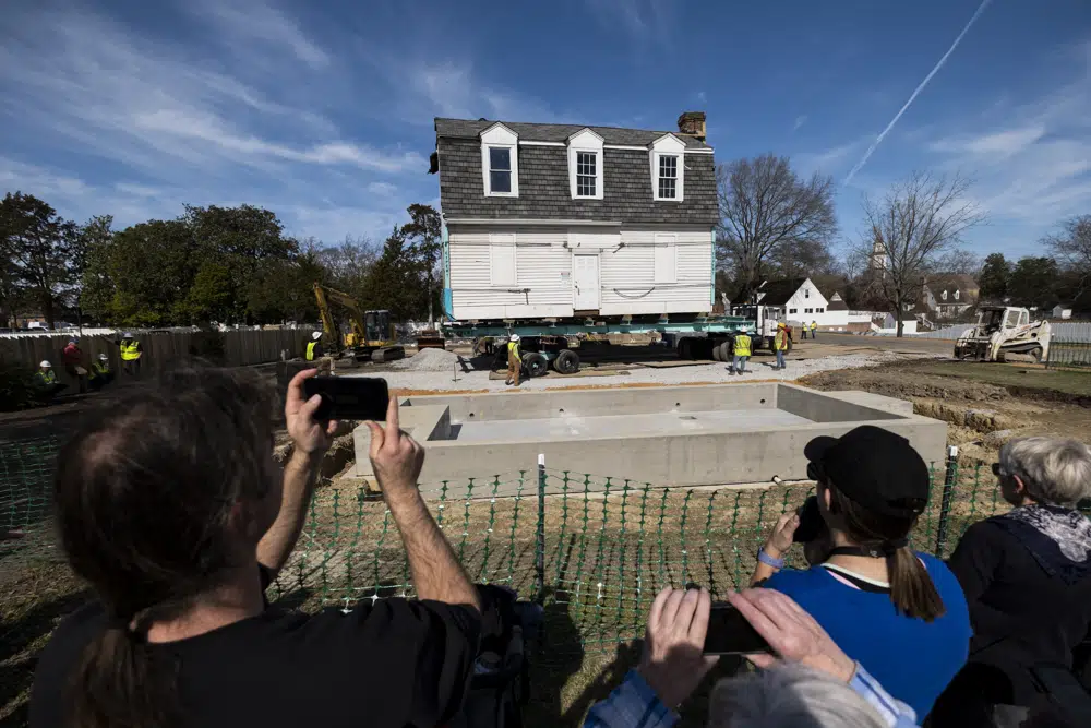 The Bray School is aligned with a set foundation at its new location in Colonial Williamsburg in Williamsburg, Va. on Friday, Feb. 10, 2023 after it was moved from the William & Mary campus. (Billy Schuerman/The Virginian-Pilot via AP)