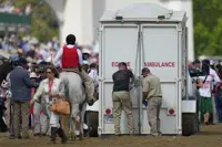 Here Mi Song is taken to the equine ambulance after the10th horse race at Churchill Downs Saturday, May 6, 2023, in Louisville, Ky. (AP Photo/Julio Cortez)
