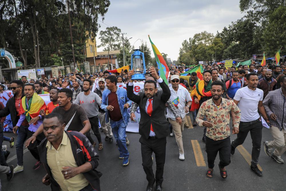 Ethiopians protest against the United States outside the U.S. embassy in the capital Addis Ababa, Ethiopia Thursday, Nov. 25, 2021. Ethiopia's government on Thursday warned the United States against spreading false information as fighting in the country's yearlong war draws closer to the capital, while thousands protested outside the U.S. and British embassies. (AP Photo)