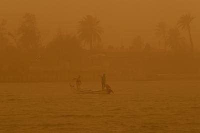 Los pescadores navegan en la vía fluvial Shatt al-Arab durante una tormenta de arena en Basora, Irak, el lunes 23 de mayo de 2022. (AP Foto/Nabil al-Jurani)