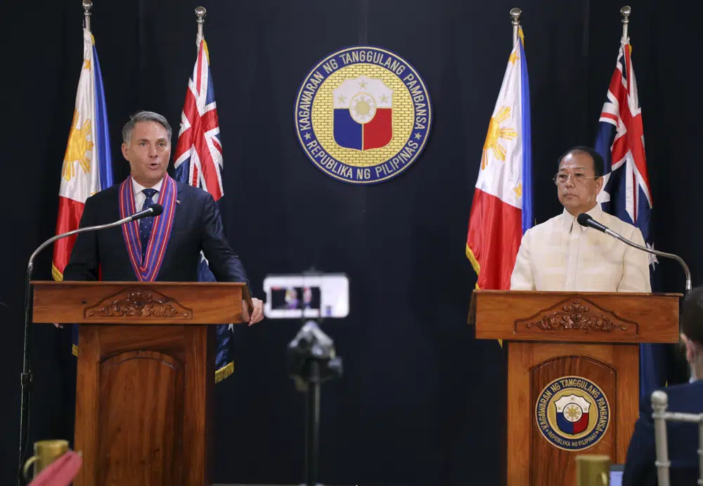 In this photo provided by the Department of National Defense, Defense Communications Service, Australian Deputy Prime Minister and Defense Minister Richard Marles, left, talks beside Philippines Defense Chief Carlito Galvez Jr. during his visit at Camp Aguinaldo in Quezon City, Philippines on Wednesday Feb. 22, 2023. (Department of National Defense, Defense Communications Service via AP)