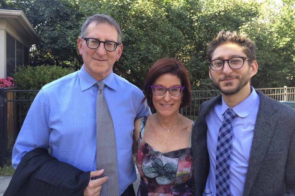 Buddy, from left, and Rose Fenster, and their son Danny Fenster pose for a photo in Huntington Woods, Mich., in 2014. A court in military-ruled Myanmar on Friday, Nov. 12, 2021, sentenced detained U.S. journalist Danny Fenster to 11 years in prison after finding him guilty on several charges, including incitement for allegedly spreading false or inflammatory information. (family courtesy photo via AP)