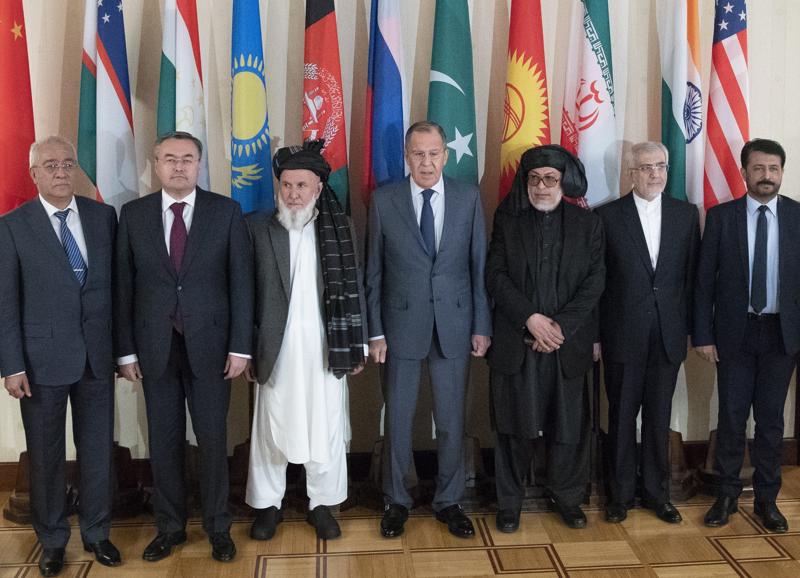 FILE - In this Thursday, July 12, 2018 file photo, Russian Foreign Minister Sergey Lavrov, center, poses for a photo with the participants of the conference on Afghanistan bringing together representatives of the Afghan authorities and the Taliban in Moscow, Russia. The Taliban’s lightning takeover of Afghanistan has come as no shock to Russia, which has worked methodically for years to lay the groundwork for future relations with the group it still officially considers a terrorist organization. Moscow, which fought a 10-year war in Afghanistan that ended with Soviet troops’ withdrawal in 1989, has made a comeback as an influential power broker in international talks on Afghanistan in recent years. (AP Photo/Pavel Golovkin, File)