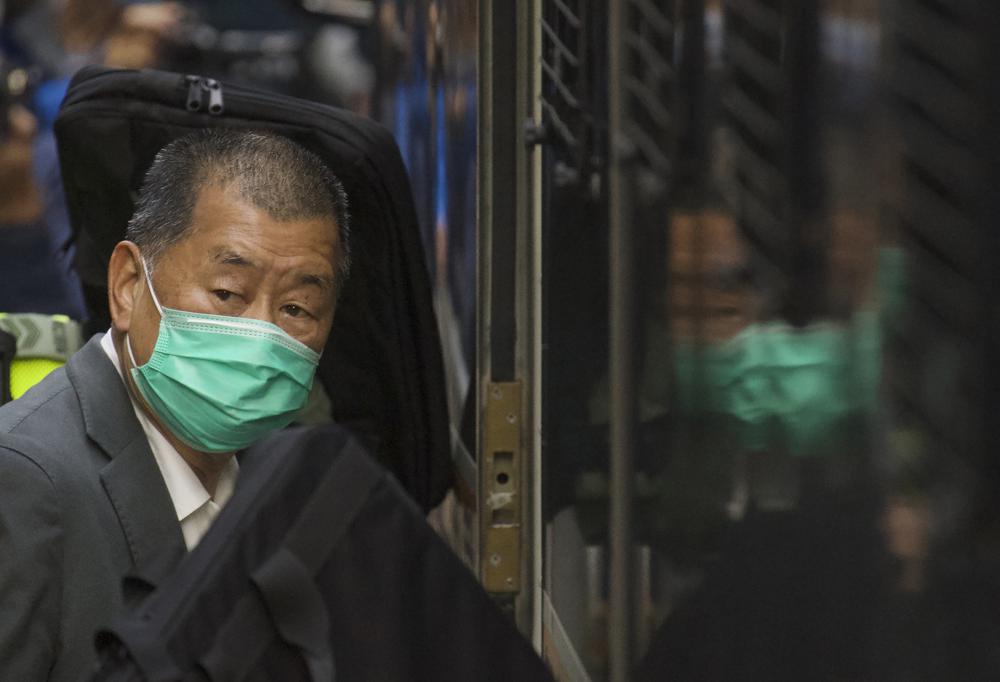 FILE - In this Feb. 1, 2021, file photo, democracy advocate Jimmy Lai leaves the Hong Kong's Court of Final Appeal in Hong Kong. Lai was given a sentence of 13 months in jail Monday, Dec. 13, 2021, for urging participation in last year’s banned Tiananmen candlelight vigil, while seven others convicted on similar charges received sentences of up to 14 months. (AP Photo/Vincent Yu, File)